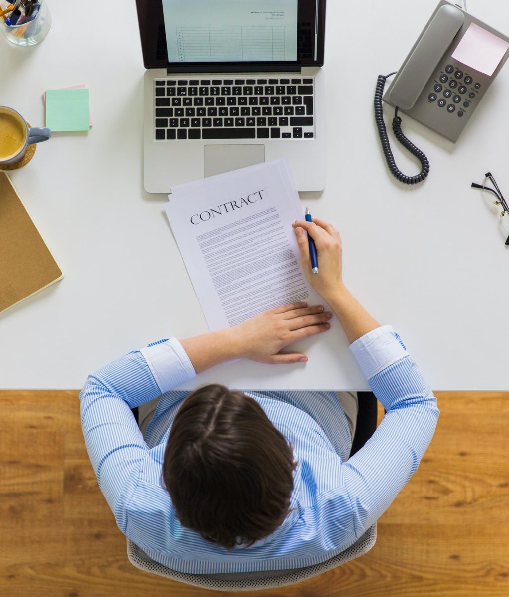 businesswoman-signing-contract-document-at-office.jpg
